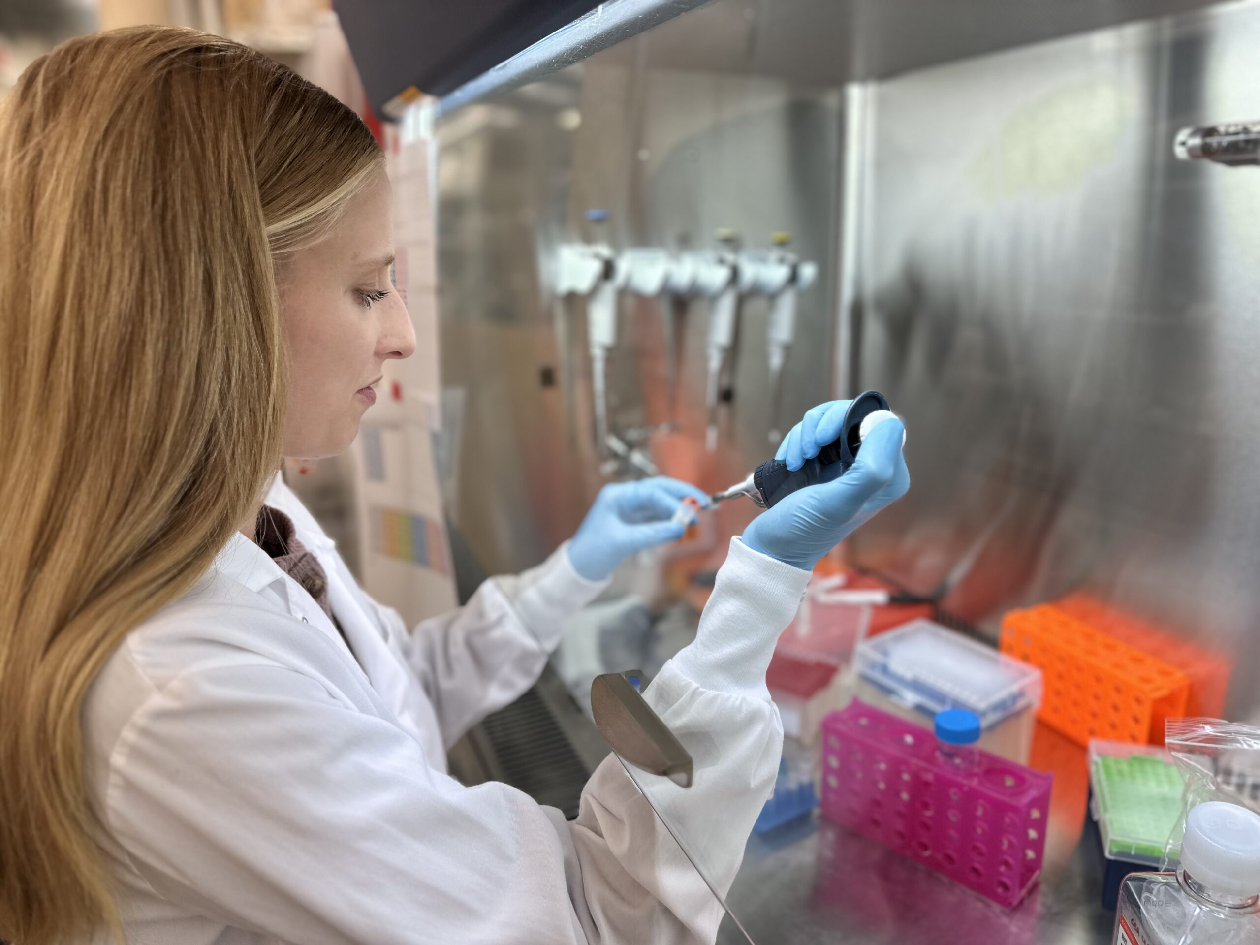 Scientist pipetting samples in a biologics discovery lab